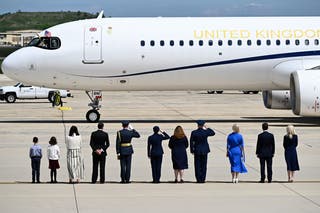Greeters stand on the tarmac after Britain's King Charles III and Britain's Queen Camilla's plane landed at Joint Base Andrews, Maryland, on April 27, 2026.
